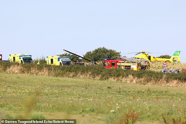 A helicopter joins emergency services at the crash site on Monday morning