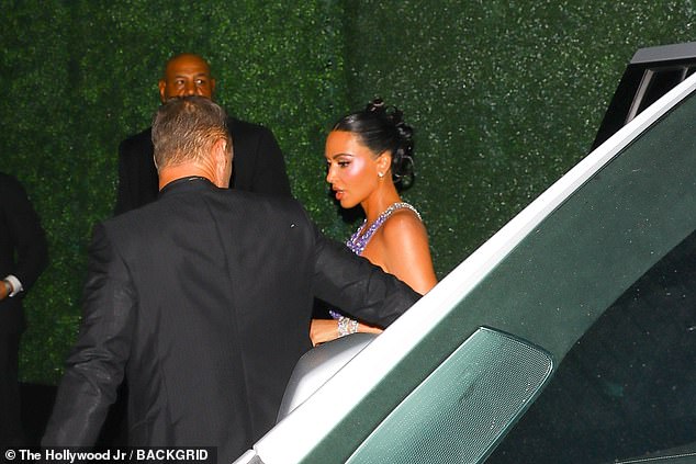 Kim Kardashian, having just failed the bar exam, brushed herself off and glammed up for the a night out in a sensational royal purple dress