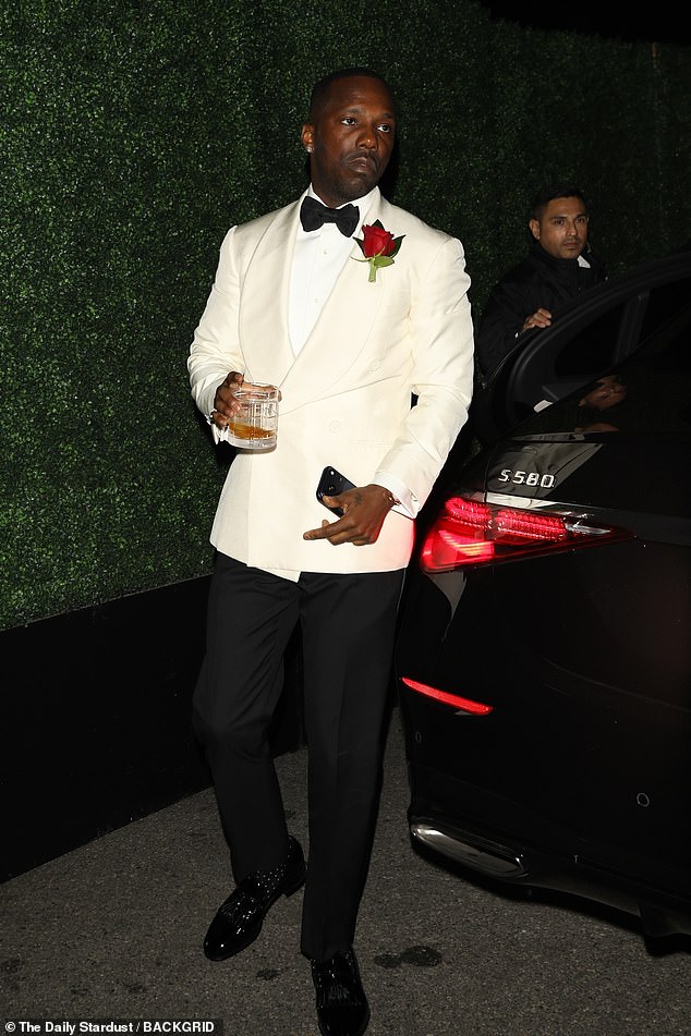 Adele arrived on the arm of her husband Rich Paul, who could be seen drink in hand, looking dapper as ever in a mismatched suit of a cream jacket and black slacks