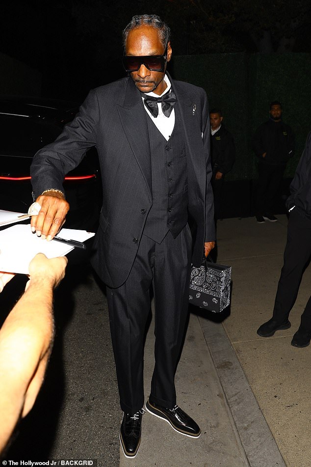 Meanwhile Martha's longtime friend and colleague Snoop Dogg wore a three-piece suit and bow-tie, with the fashion forward touches of shades and a handbag