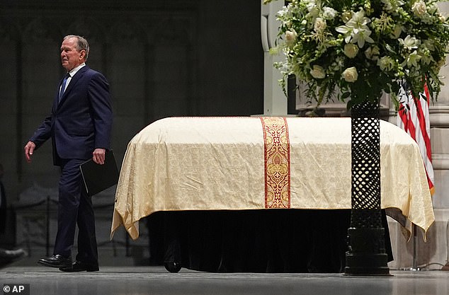 Former President George W. Bush walks by the casket with former Vice President Dick Cheney, after giving a tribute during the service at the Washington National Cathedral, Thursday, Nov. 20, 2025 in Washington. (AP Photo/Matt Rourke)