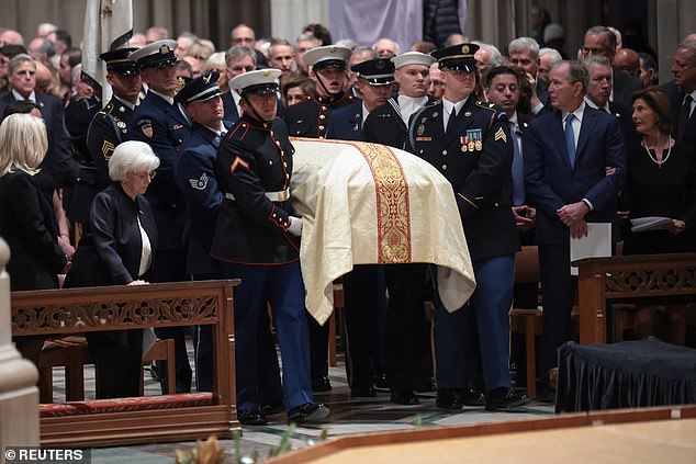 A U.S. military honor guard carries former Vice President Dick Cheney's casket during at the start of his funeral service, at Washington National Cathedral in Washington D.C., U.S., November 20, 2025. REUTERS/Jonathan Ernst