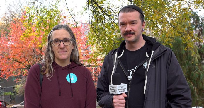 two people standing in a park