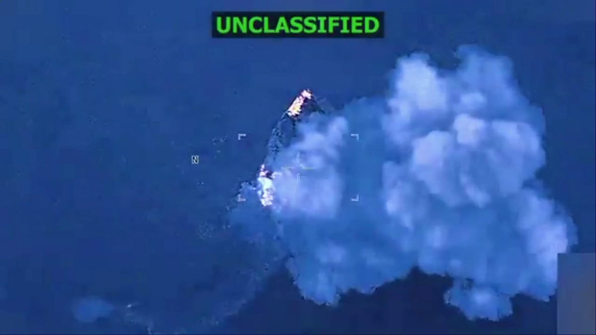 vessel on fire as smoke billows into sky