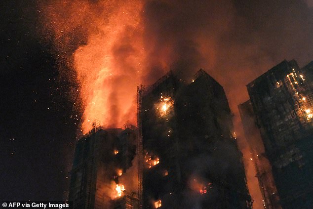 Thick smoke and flames rise as a major fire engulfs several apartment blocks at the Wang Fuk Court residential estate in Hong Kong's Tai Po district on November 26, 2025