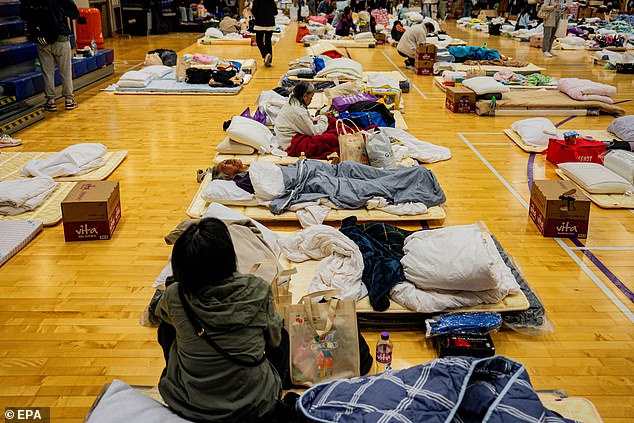 People affected by the apartment fire in the Tai Po district rest at an emergency shelter, Hong Kong, China, 27 November 2025