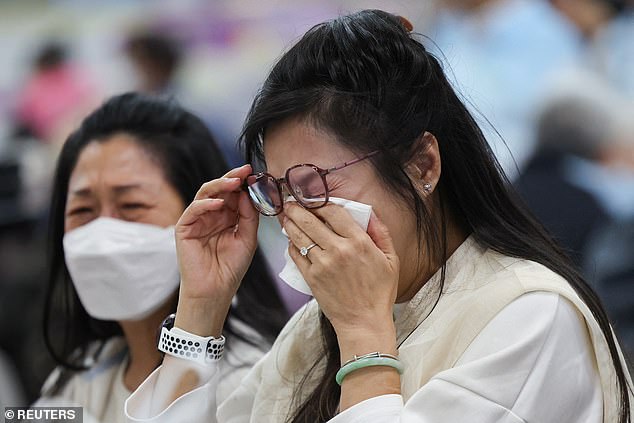 A woman reacts at a temporary shelter, after a fire started across multiple buildings at Wang Fuk Court housing estate, in Tai Po, Hong Kong, China, November 26, 2025