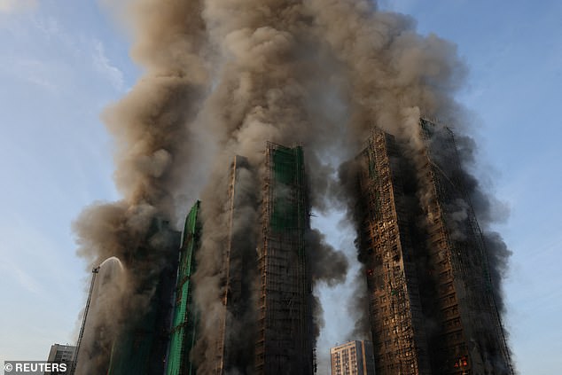 Smoke rises as flames engulf bamboo scaffolding across multiple buildings at Wang Fuk Court housing estate, in Tai Po, Hong Kong, China, November 26, 2025