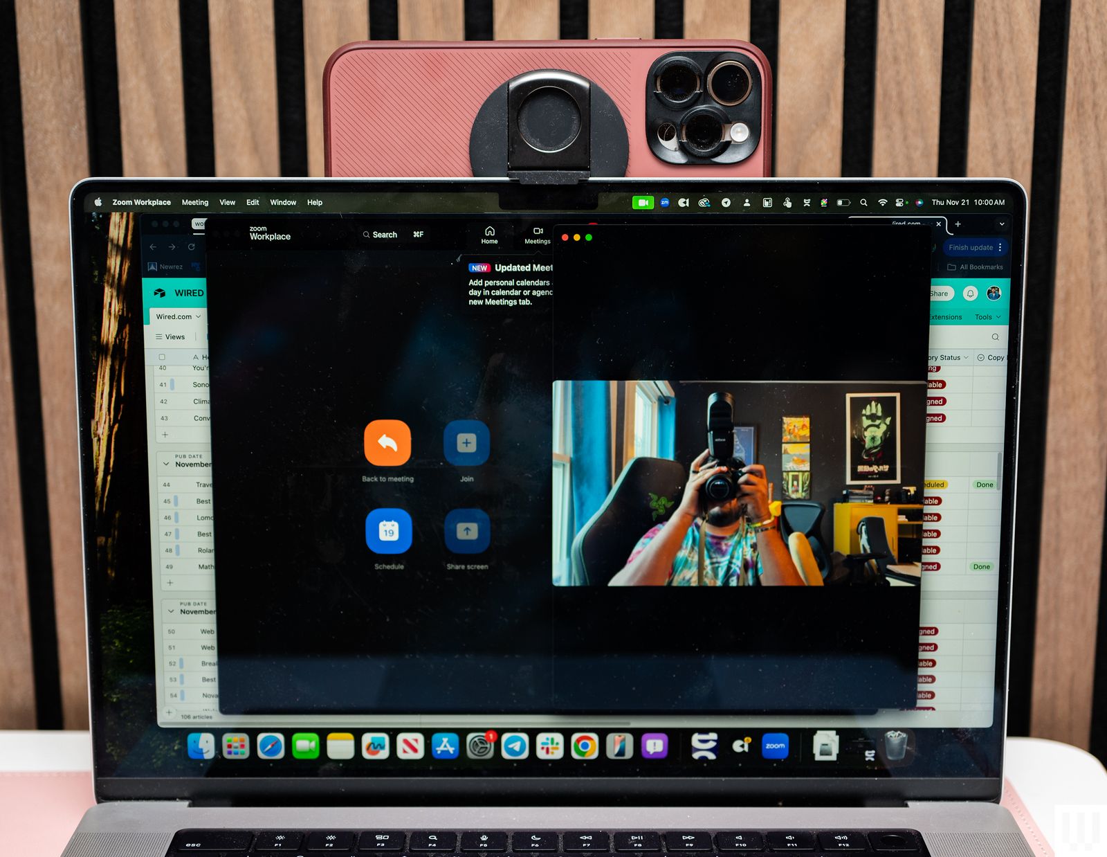 Laptop with Belkin iPhone Mount connected and pink mobile phone on the top