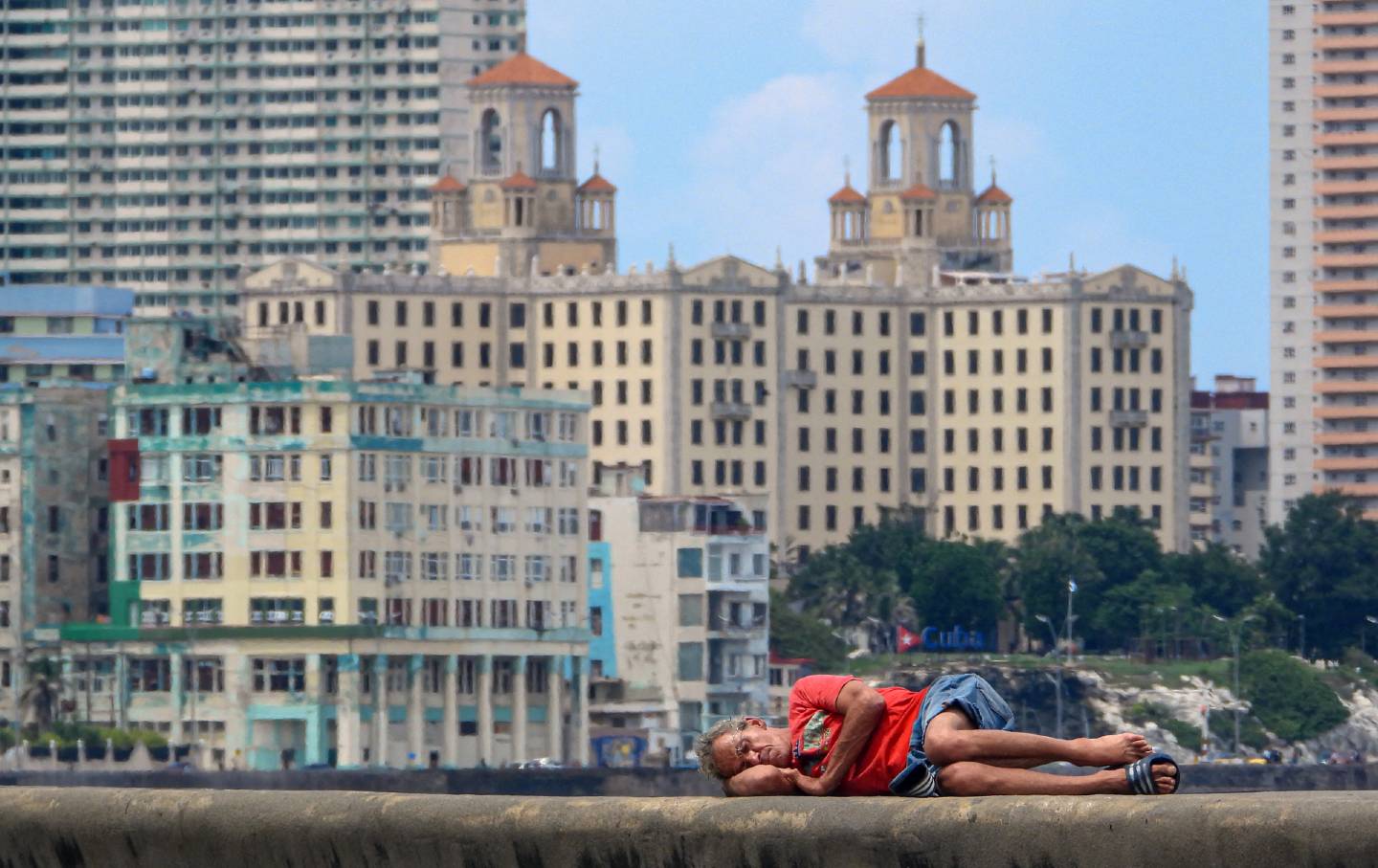 A man sleeps on Havana's Malecon waterfront