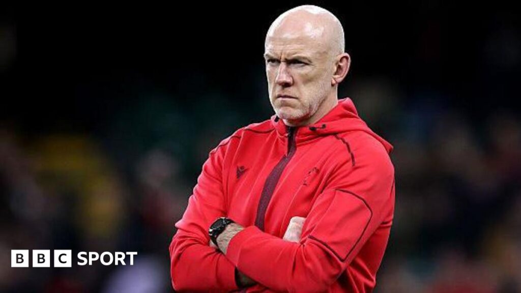 Wales coach Steve Tandy watches his side warm up