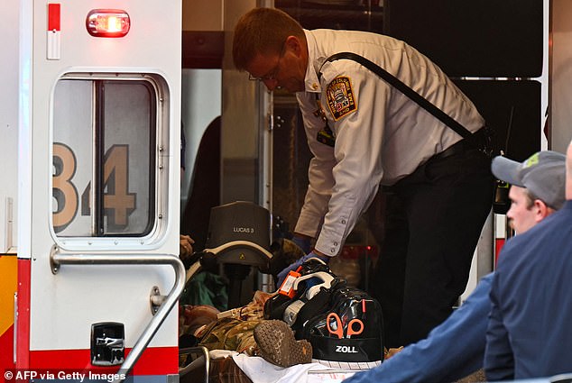 A stricken soldier in the back of an ambulance after being shot near the White House