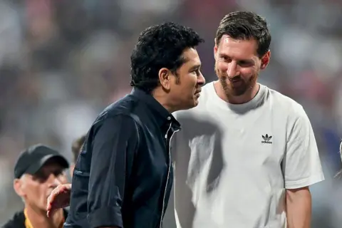 Getty Images Indian cricketer Sachin Tendulkar interacts with Argentine footballer Lionel Messi during the Lionel Messi G.O.A.T Tour on December 14, 2025 in Mumbai, India. 