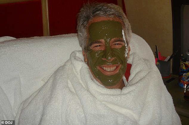 Epstein is pictured in a green face mask while wrapped in towels