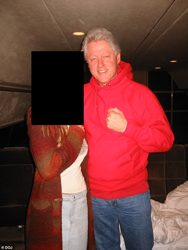 Clinton, wearing a red hoodie, is pictured with an unknown woman