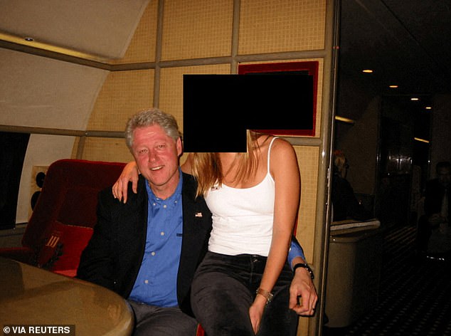 Former president Clinton poses with an unknown woman