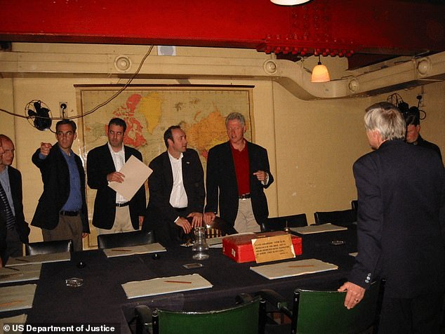 Clinton, Spacey and others huddled around a desk at the War Rooms in central London
