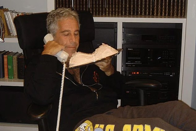 Epstein is seen on the phone in sweatpants and a sweatshirt with a suggestively shaped cake