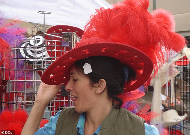 Ghislaine Maxwell poses in a red feather hat with her tongue out
