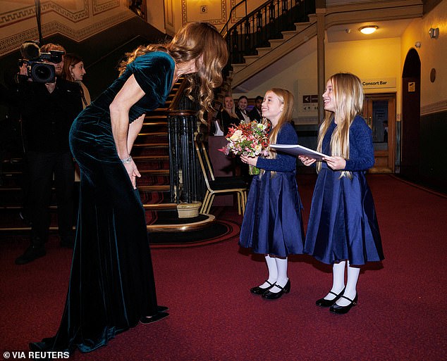 Kate paired her delightfully festive dress with matching Manolo Blahnik pumps, but the high heels didn't stop the mother-of-three from gracefully bending to greet the furriest guest of the evening