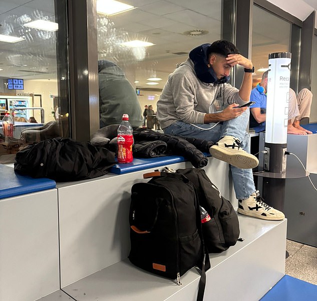 Ms Rowland's partner and other passengers waited in the terminal for their flights to be rescheduled