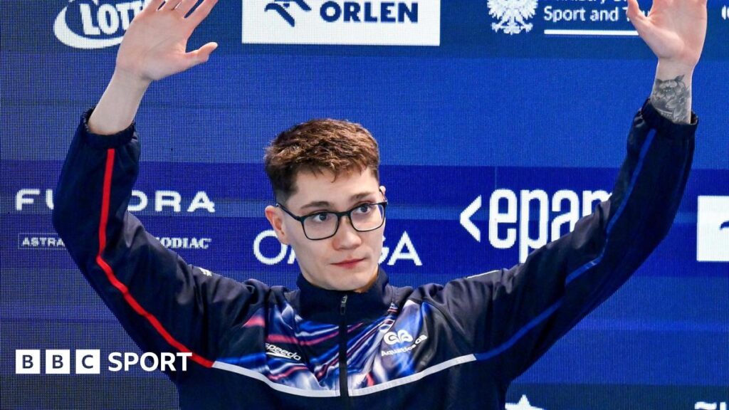 Jack McMillan waves to the crowd as he steps up to receive his gold medal