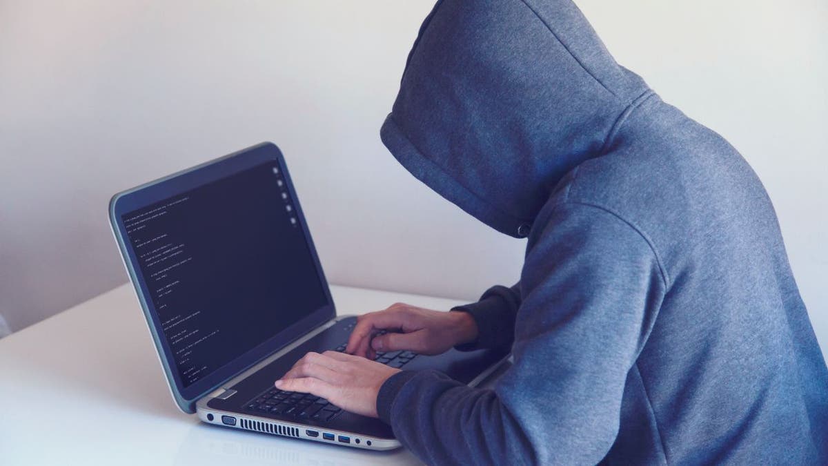 Image of hacker on laptop