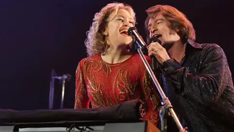 Focus Features Hugh Jackman and Kate Hudson performing with a keyboard in Song Sung blue