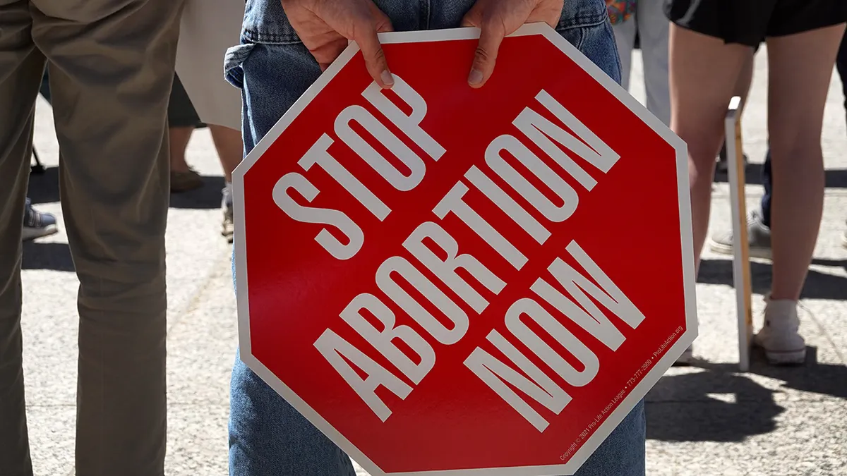 Anti-abortion demonstrator holding sign