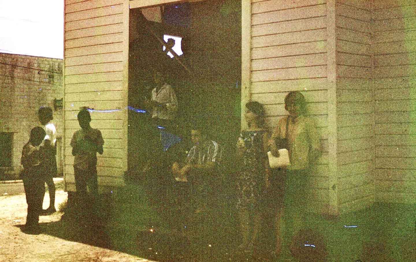 SCLC volunteers, including Gitin (second from right), gather outside the organization's Wilcox County headquarters, historic 1885 Antioch Baptist Church, one morning after it was broken into and vandalized.