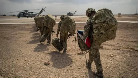 PA Media UK troops dressed in uniform and walking in a line while leaving Camp Bastion in Helmand Province, Afghanistan, 27 October 2014.