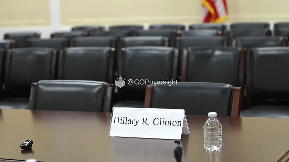 An empty chair with a reputation card for Hillary Clinton
