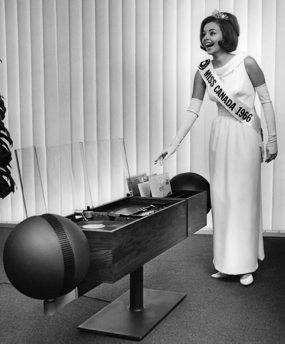 Between 1965 and 1967, Clairtone sponsored the Miss Canada beauty pageant. Miss Canada 1963 was Diane Landry, seen here with a Project G2 at Clairtoneu2019s factory showroom in Rexdale, Ontario.