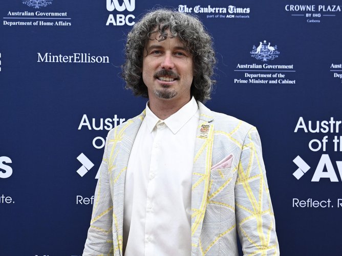 Mr Mitchell donned a suit with measuring tape printed on it for the event. Picture: NewsWire / Martin Ollman