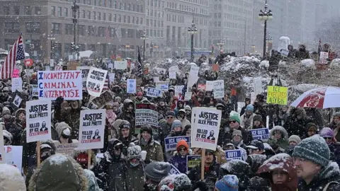 Getty Images Demonstrators gather on Michigan Avenue, Chicago, during a heavy snowstorm to protest against US Immigration and Customs Enforcement.