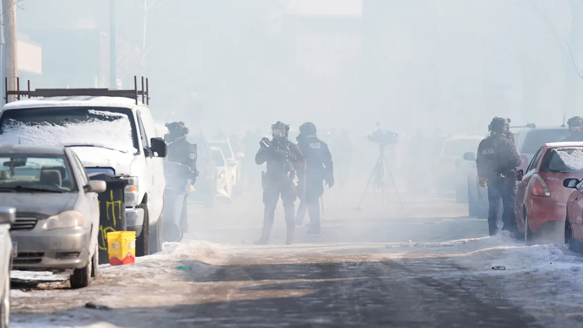 Federal agents stand in tear gas