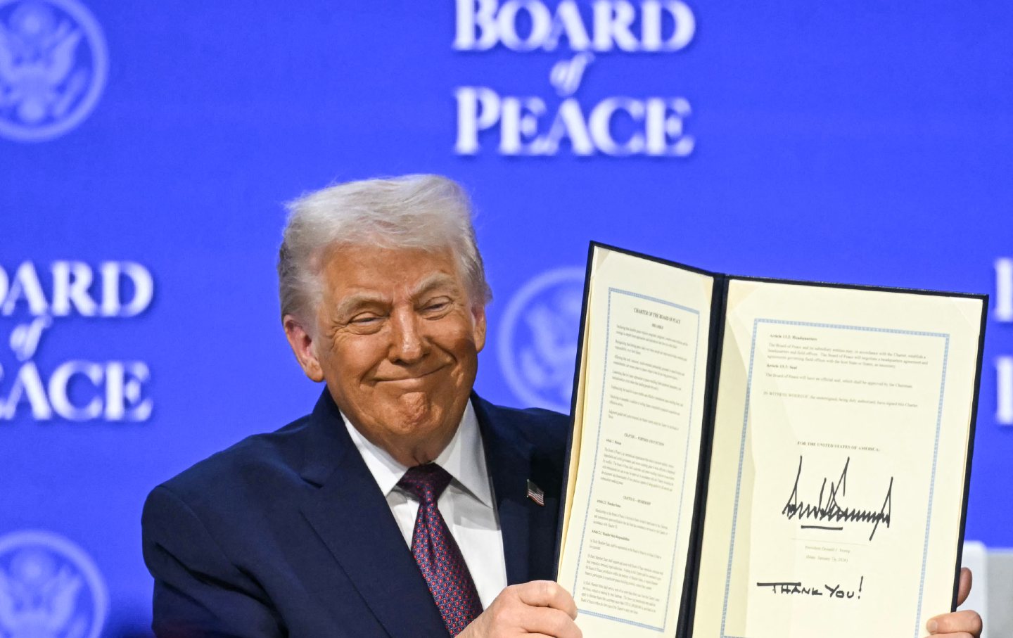 Donald Trump holds a signed founding charter for the “Board of Peace” during the World Economic Forum annual meeting in Davos.