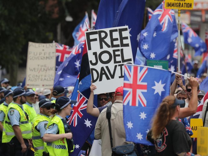 A ‘Free Joel Davis’ sign at Sydney’s Australia Day March for Australia rally. Mr Davis, a former senior NSN member, is accused of harassing an MP via a carriage service. Picture: NewsWire / Christian Gilles