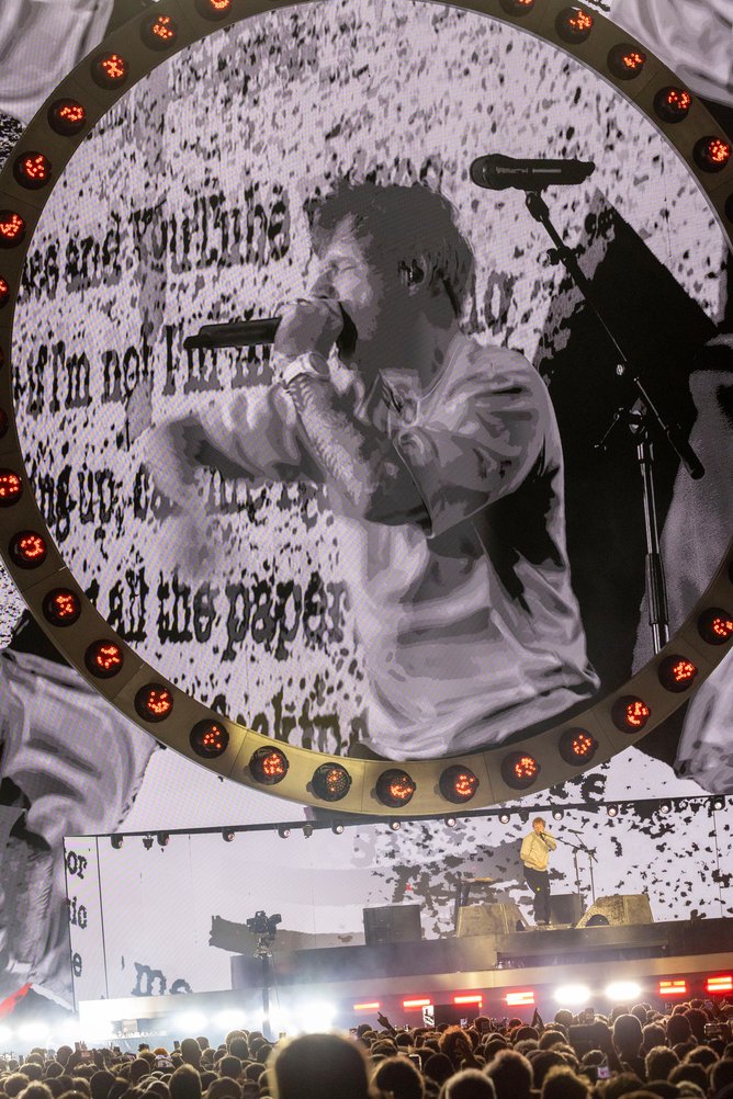 Huge LED screen displaying graphics matching the topics of Sheeran’s songs.