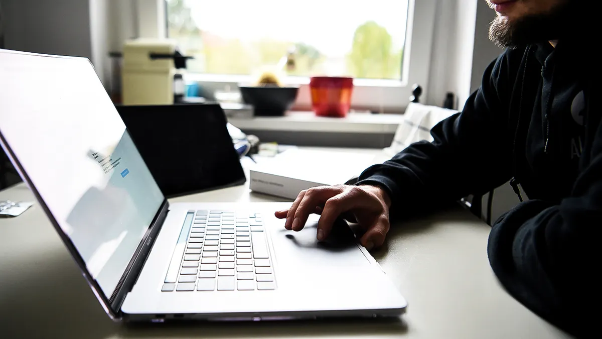 A man typing on his laptop.