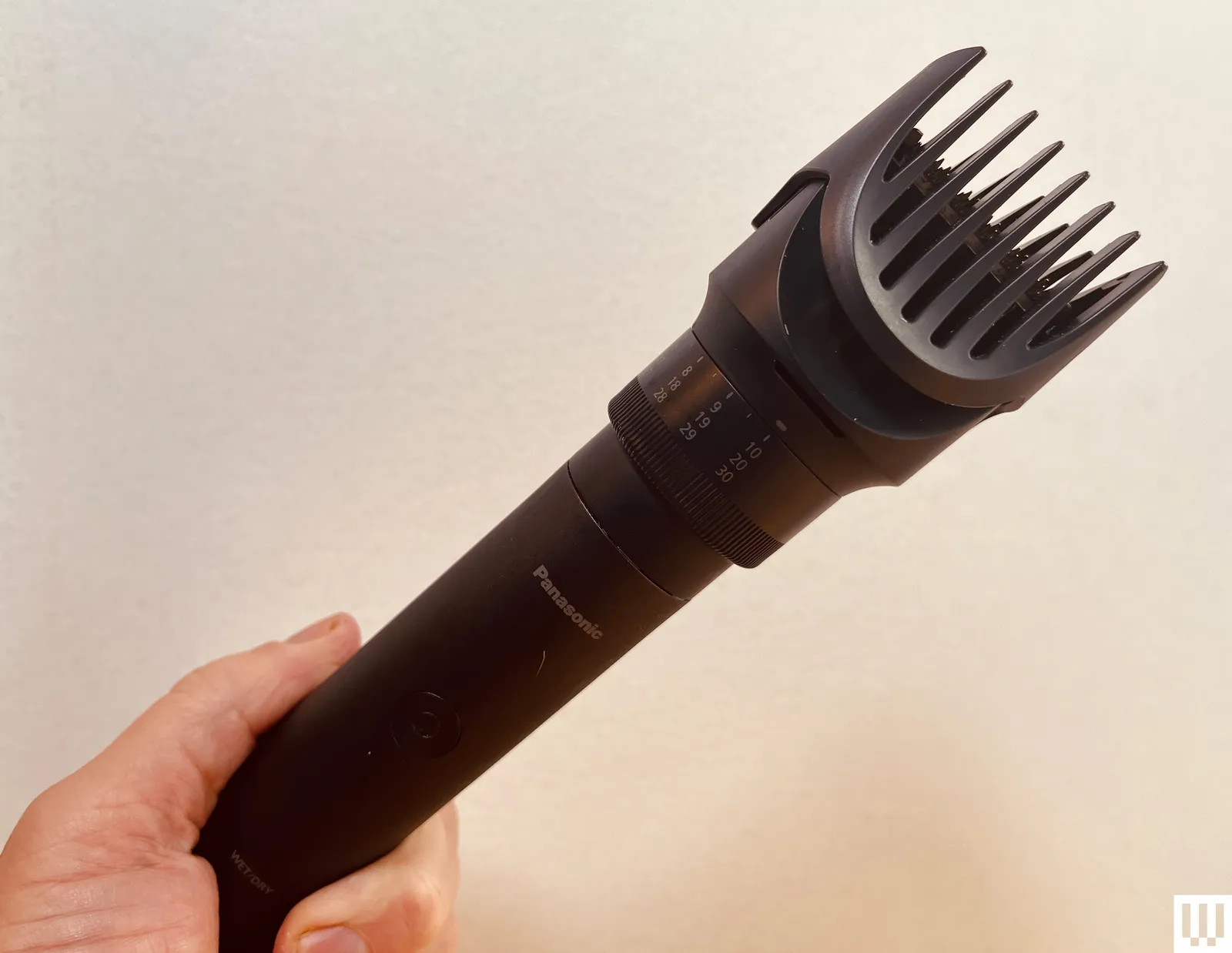 Philips Multigroom a black electric beard trimmer in hand