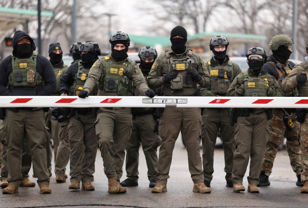 US Border Patrol agents stand guard at the Bishop Henry Whipple Federal Building in Minneapolis, Minnesota, on January 8, 2026. (Photo by CHARLY TRIBALLEAU / AFP via Getty Images)