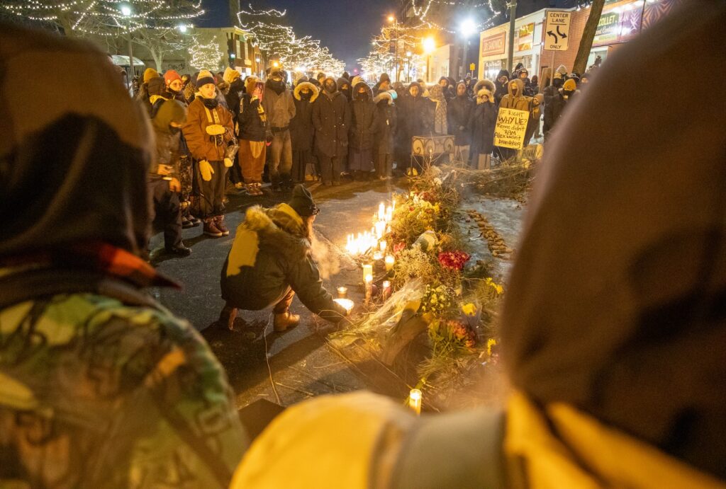 Protesters hold a vigil over the spot where federal agents killed Alex Pretti in Minneapolis, United States, on January 24, 2026. (Photo by Arthur Maiorella/Anadolu via Getty Images)