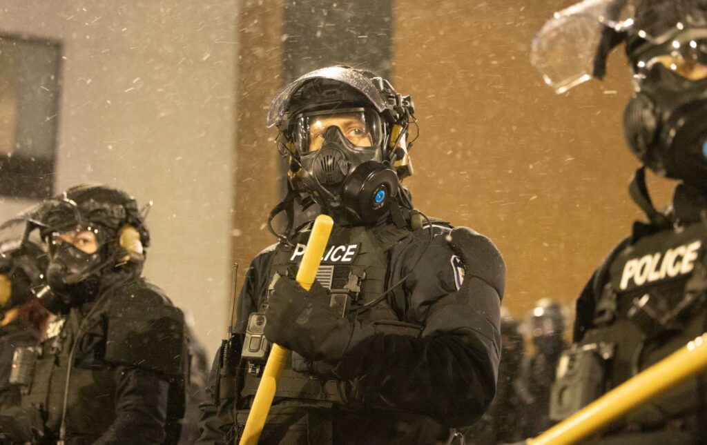 Protesters clash with law enforcement while holding a