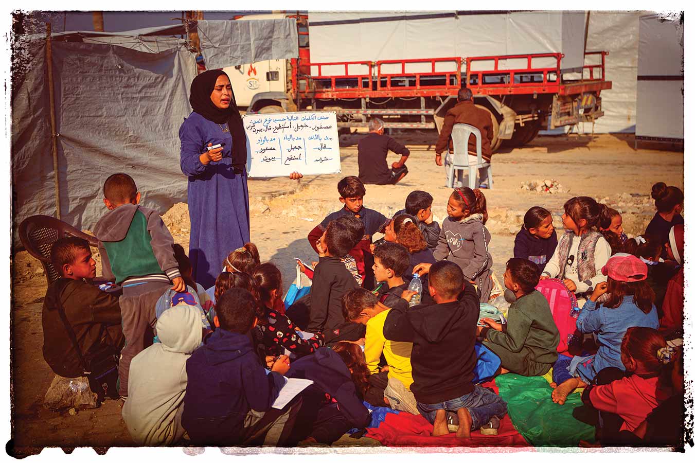 Students attend school in an outdoor classroom in Gaza, November 18, 2025.
