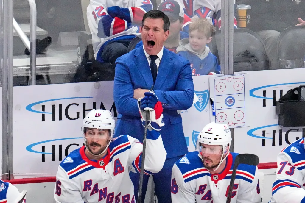 New York Rangers head coach Mike Sullivan yells instructions during a hockey game.