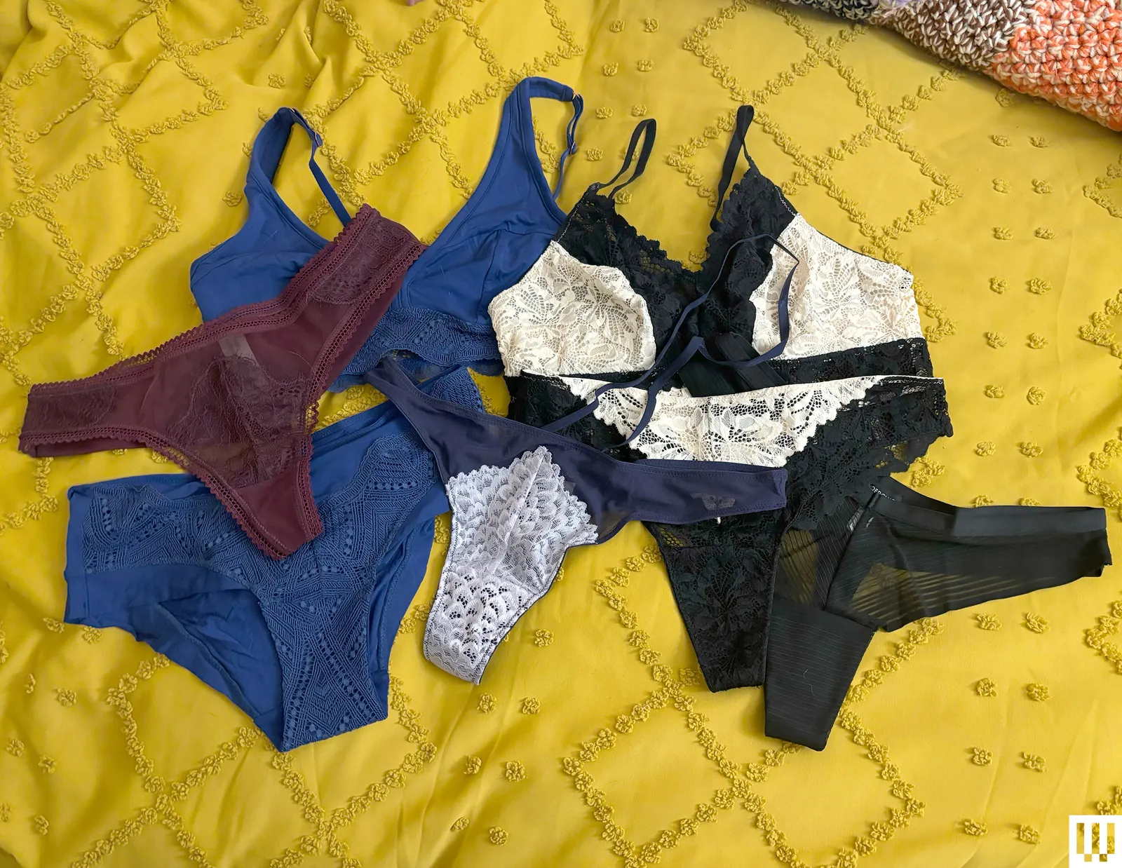 Underwear from the Underclub Subscription Box scattered on a yellow blanket